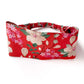 Liberty London Tana Lawn cotton  headband with an orange red background and a floral print featuring cream-colored flowers, pink blossoms, and green leaves, displayed on a clean white background.