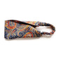A Liberty London Tana Lawn cotton headband with a colorful paisley pattern on a navy blue background, featuring a gathered elastic band, shown on a plain white background.