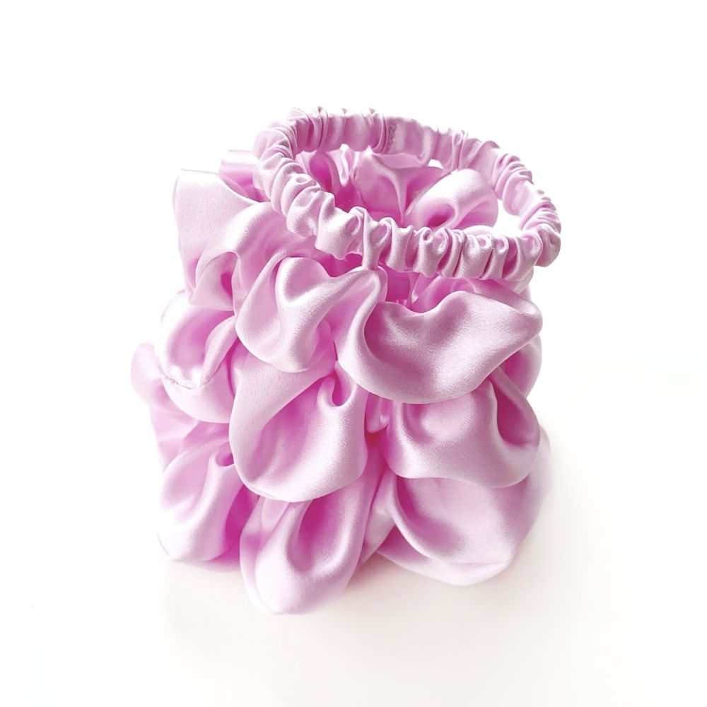 Set of lilac pure mulberry silk satin scrunchies and hair ties on a white background