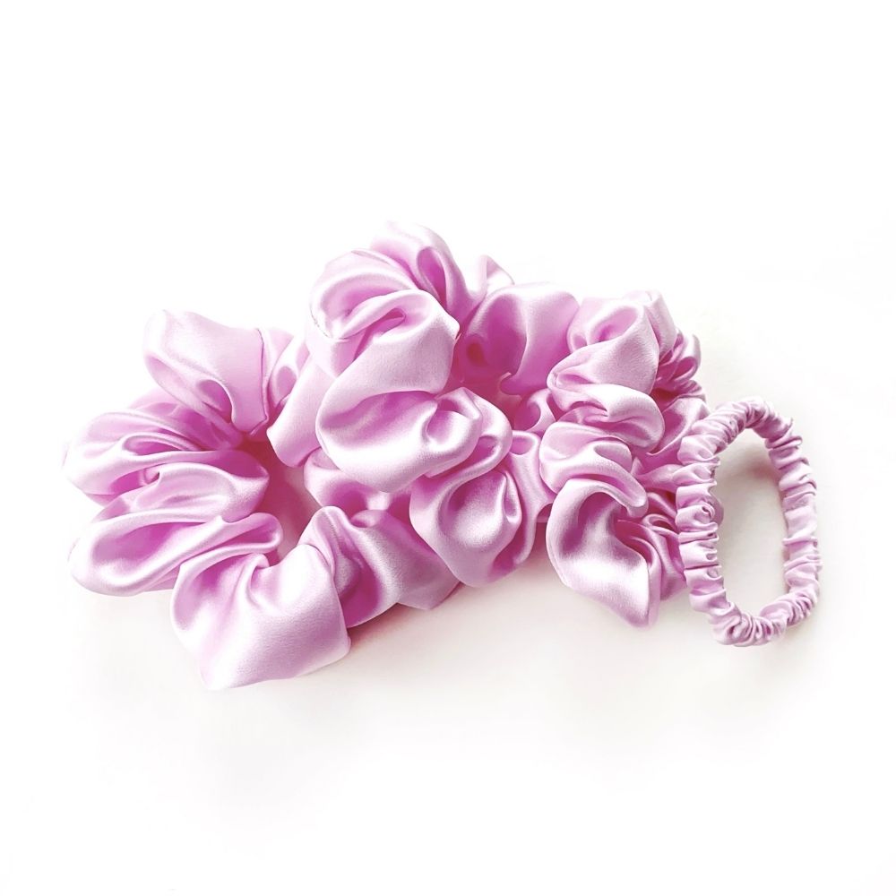Set of lilac pure mulberry silk satin scrunchies and hair ties on a white background