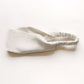 A ivory white linen headband with an elastic back, laid flat on a clean white background.