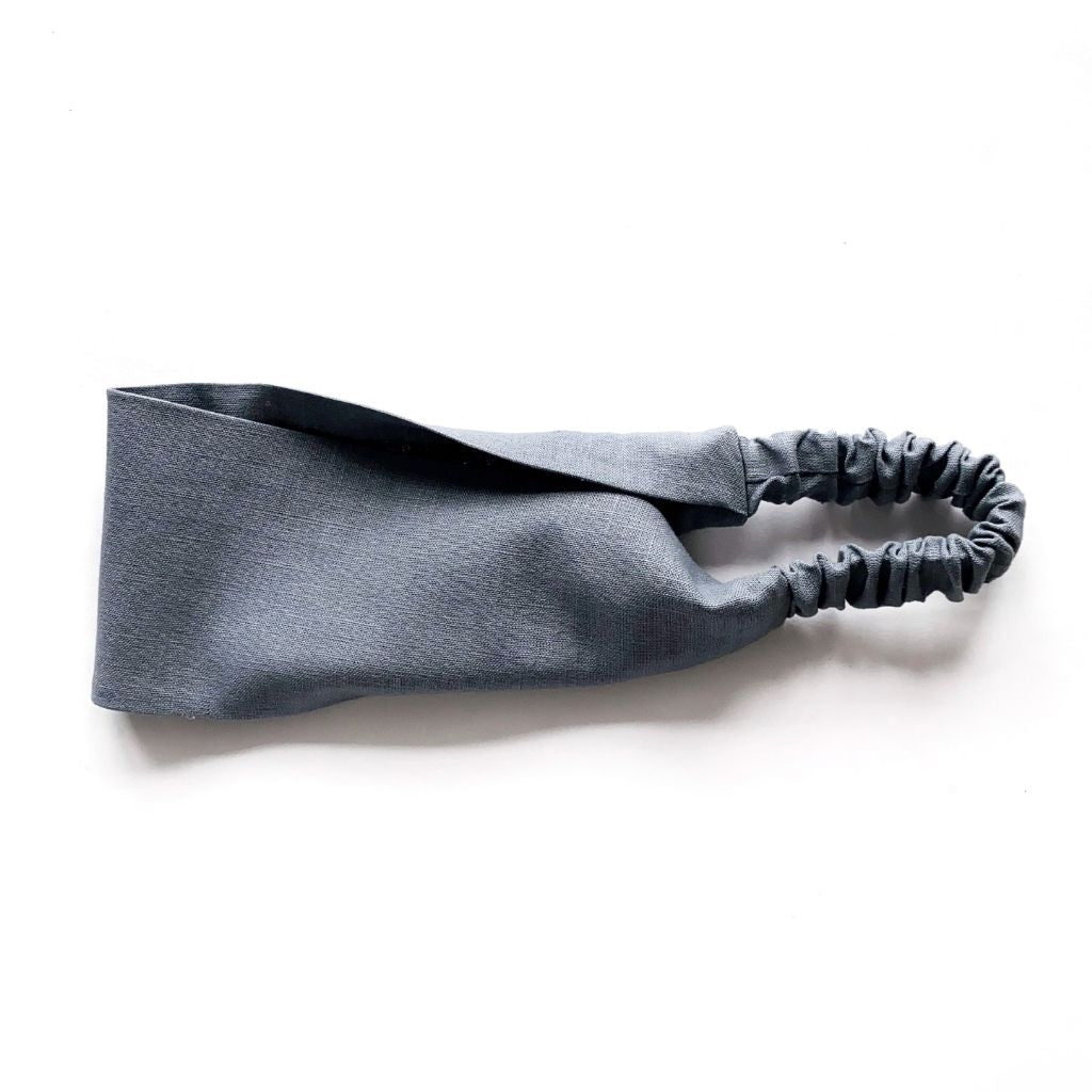 A steel gray flat linen headband with an elastic back, displayed on a clean white background.