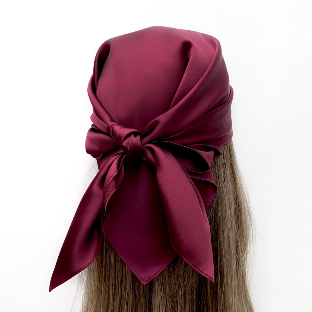 mannequin wears a burgundy mulberry silk square head scarf around her head