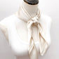 mannequin wears a solid light beige mulberry silk square bandana scarf around her neck