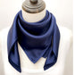 mannequin wears a solid navy blue mulberry silk square scarf around her neck