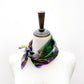 green purple mulberry silk square neck scarf on a mannequin with a white background
