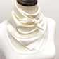 mannequin wears an ivory mulberry silk square scarf around her neck