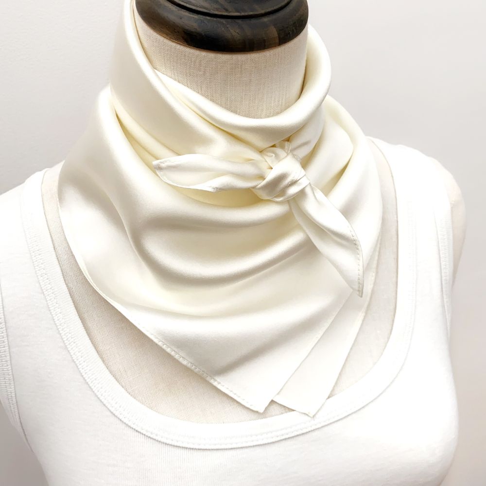 mannequin wears an ivory mulberry silk square scarf around her neck