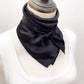 mannequin tied a black mulberry silk square scarf around her neck