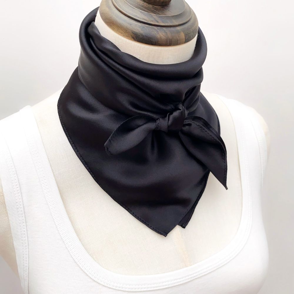mannequin tied a black mulberry silk square scarf around her neck