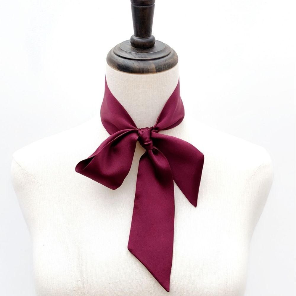 maroon mulberry silk satin skinny scarf tied around mannequin's neck