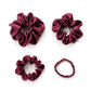 Four burgundy silk satin hair scrunchies on a white background