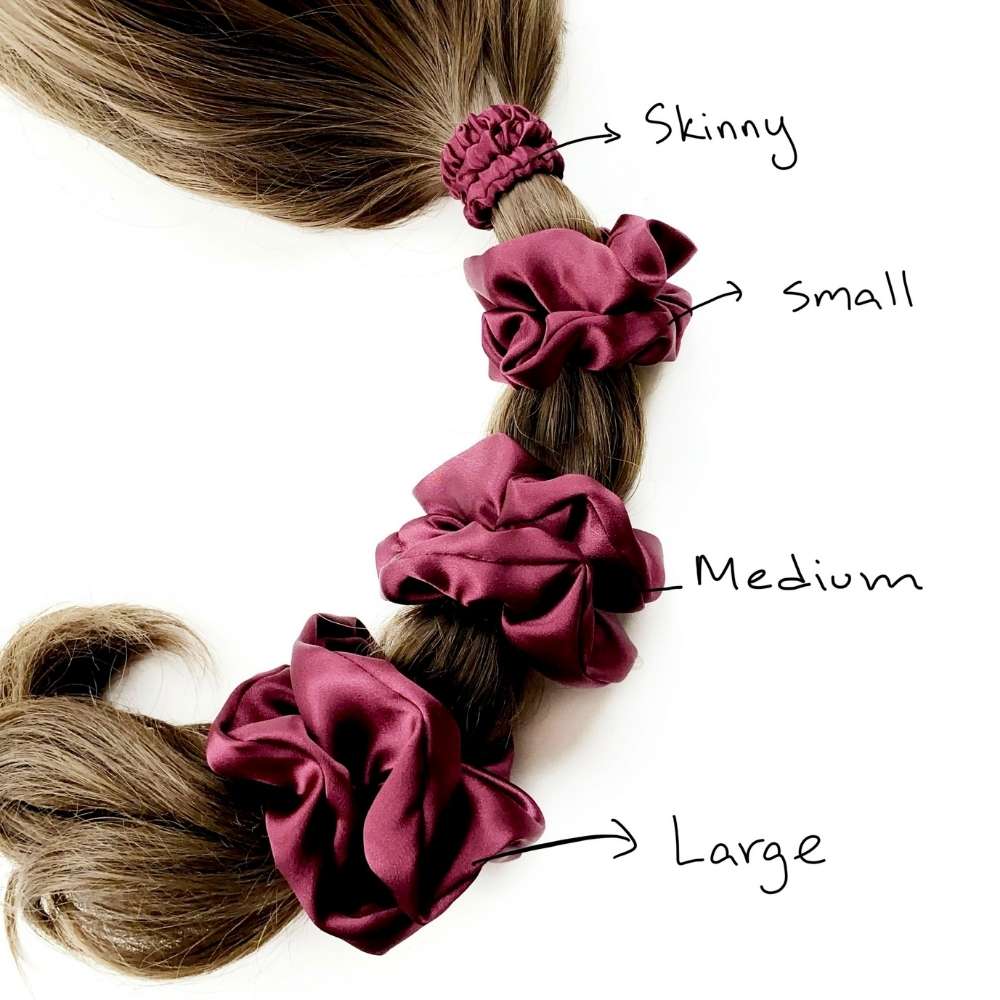 Braided hair with four burgundy silk scrunchies labeled 'Skinny', 'Small', 'Medium', and 'Large' on a white background.