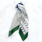 Geometric patterned mulberry silk hair scarf with green, white, and blue on a white background