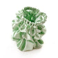 Set of mint green mulberry silk scrunchies and hair ties on a white background