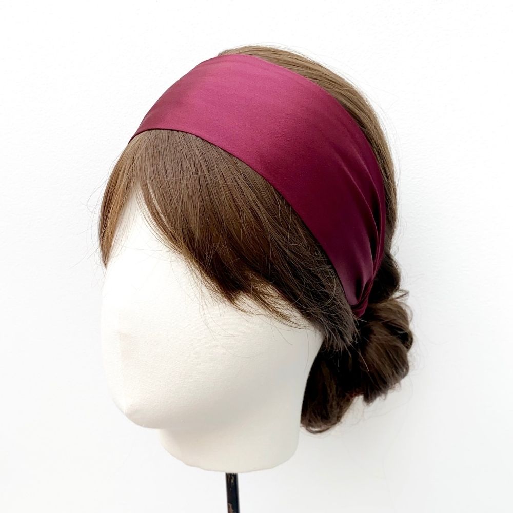 Model wearing a luxury maroon mulberry silk headband by River Minami.