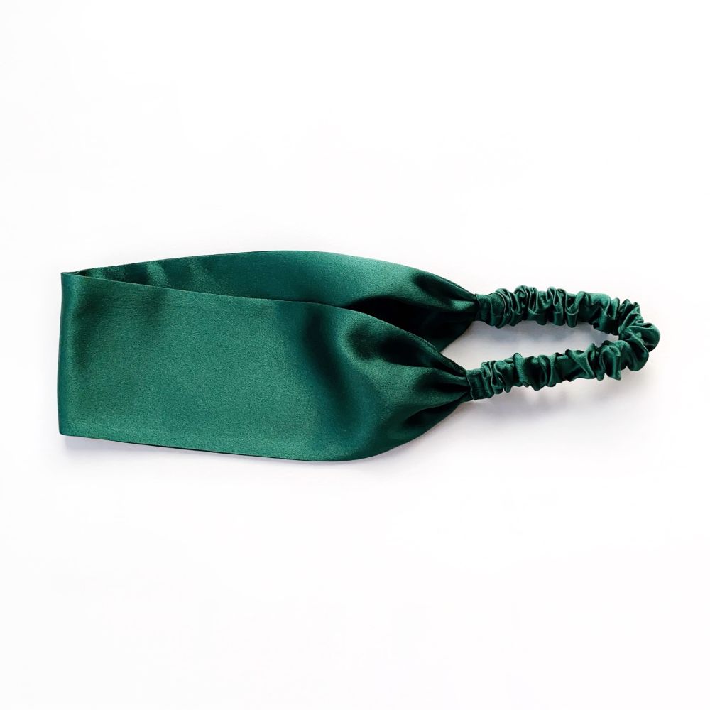 Green silk satin headband on a white background