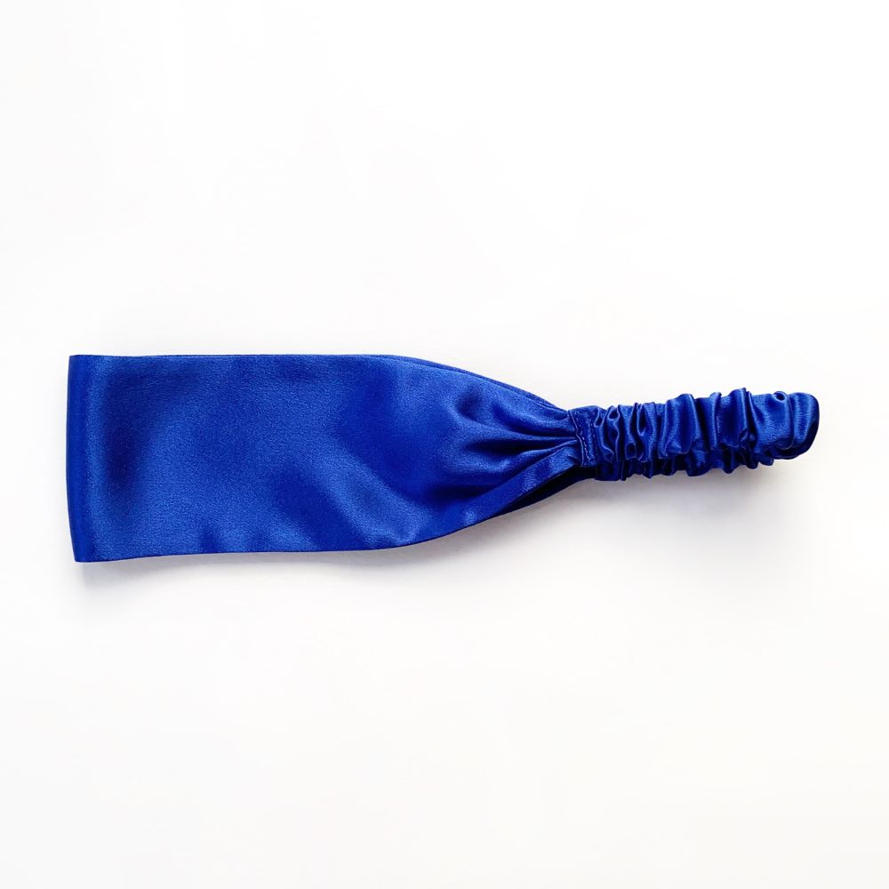 Blue silk satin headband on a white background