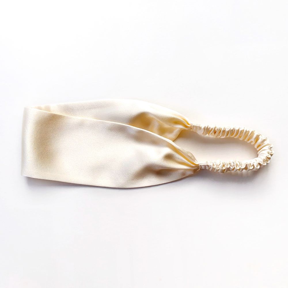 Ivory silk satin headband on a white background