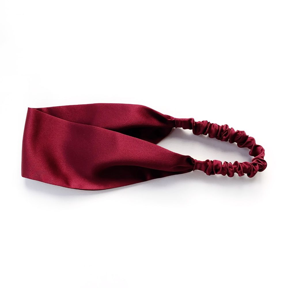 Maroon red silk satin headband on a white background