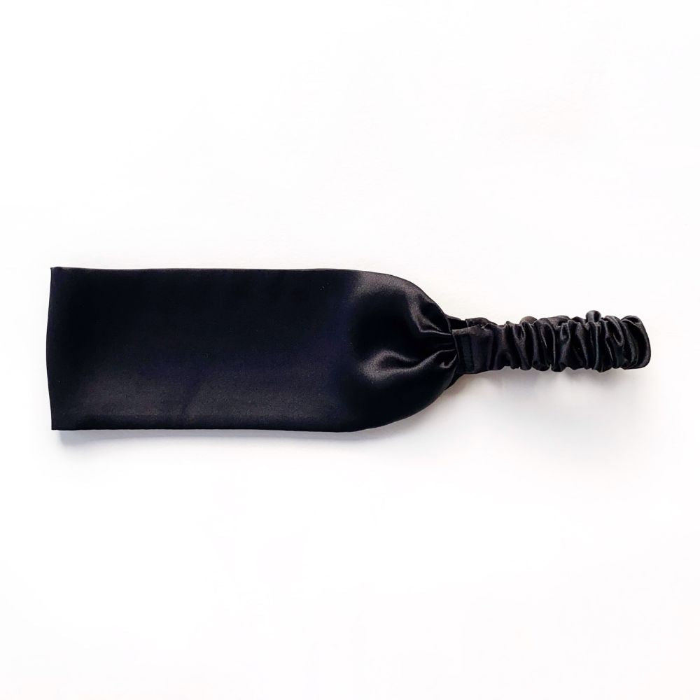 Black silk satin headband on a white background