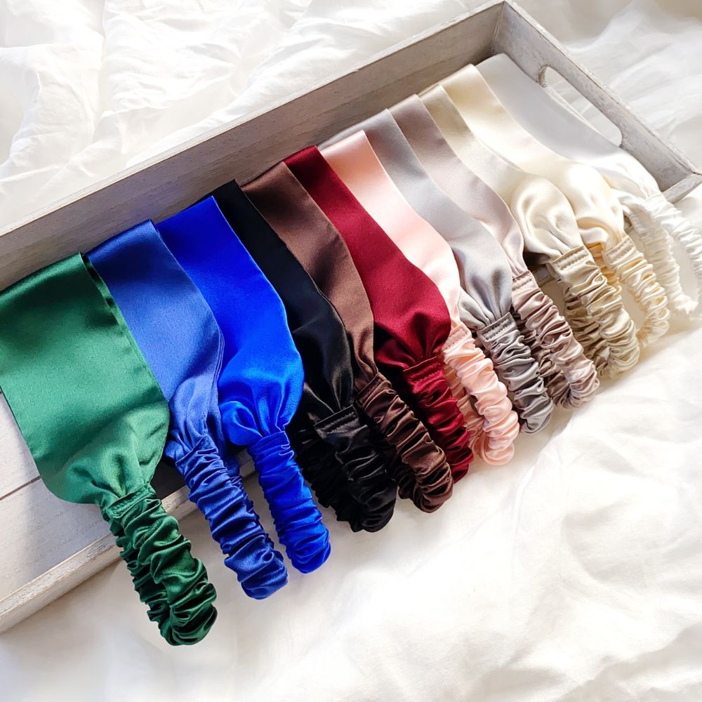 Set of colorful mulberry silk headbands on a white surface