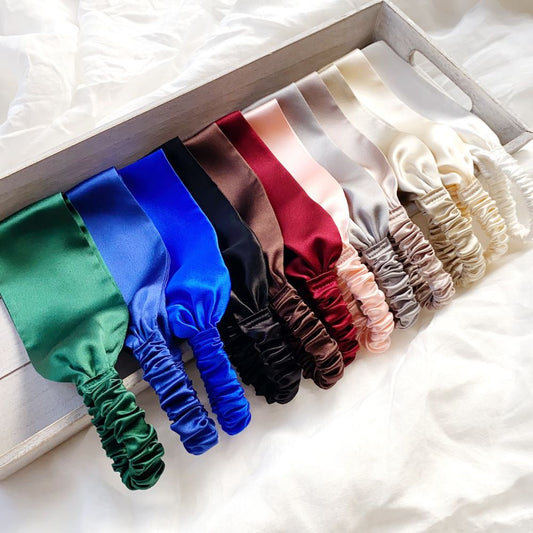 Set of colorful mulberry silk headbands on a white surface