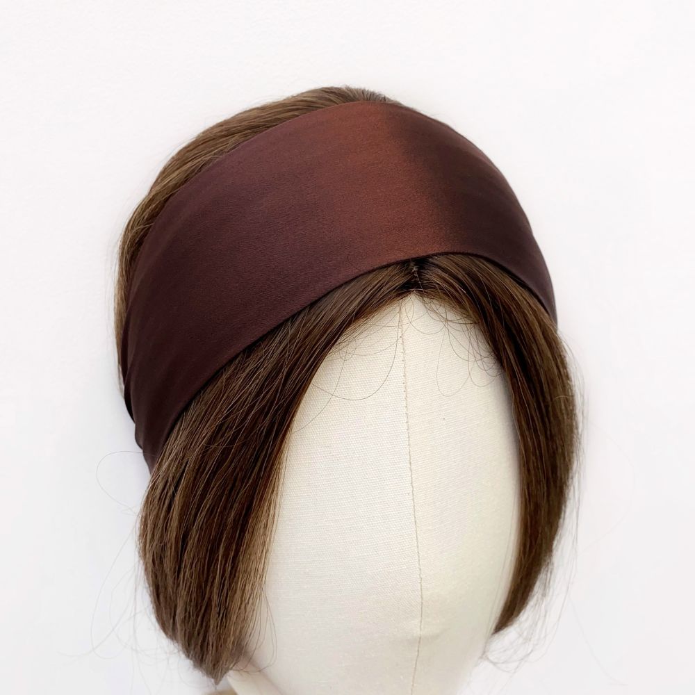 Brown silk headband on a mannequin head with brown hair against a white background