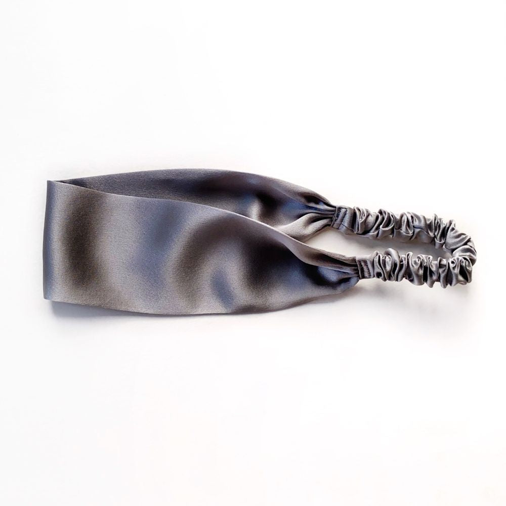 Grey silk satin headband with floral ends on a white background
