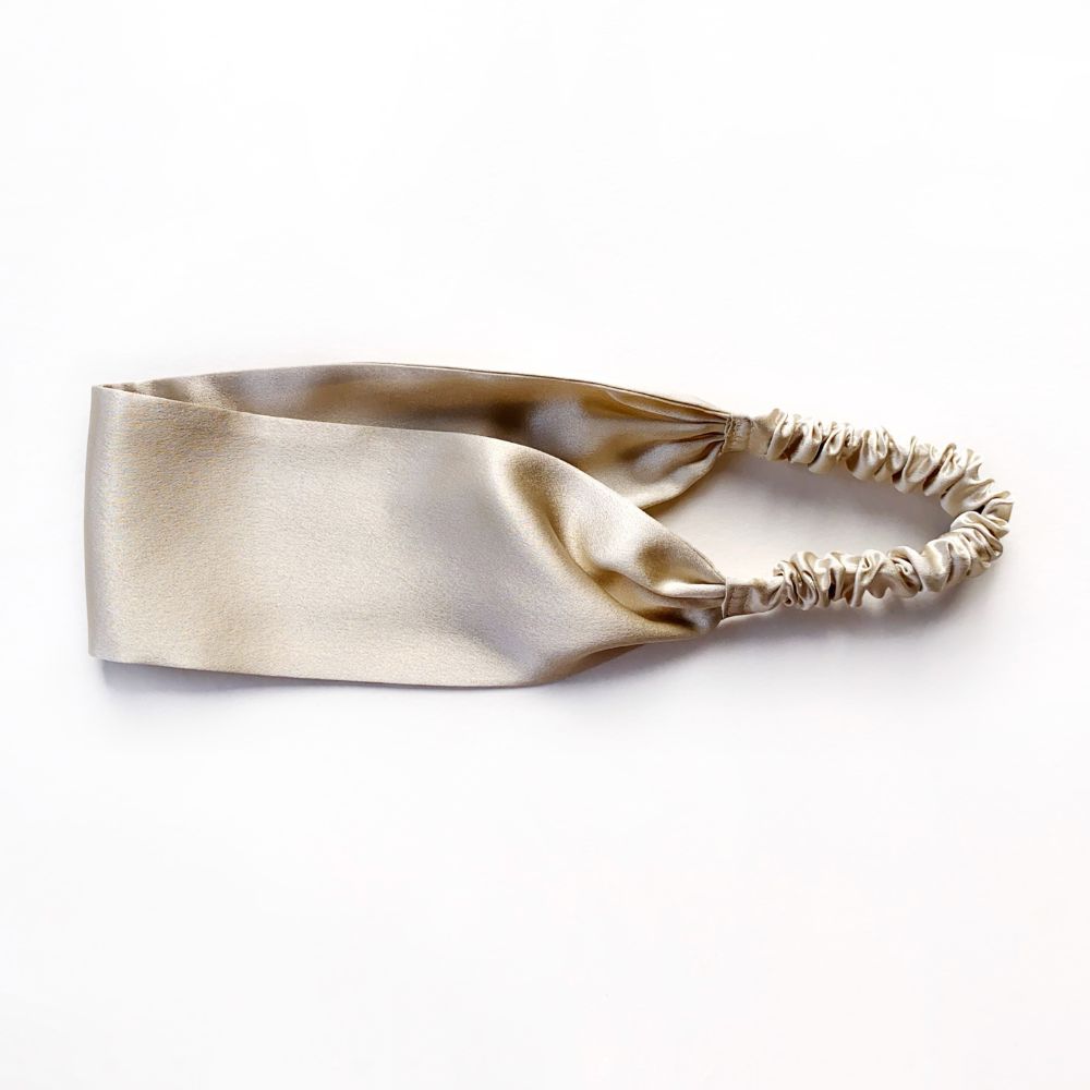 Beige silk headband on a white background