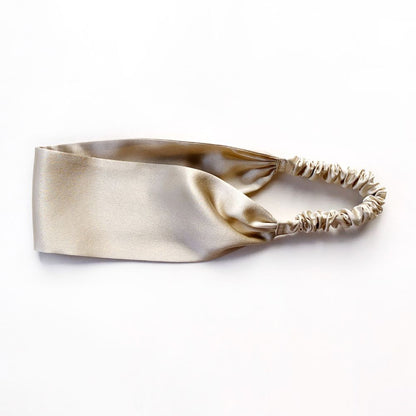 Beige silk headband on a white background
