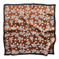 Mulberry silk square scarf with a black and white line art floral pattern on a brown background, framed with a black border and laid flat on a white background.