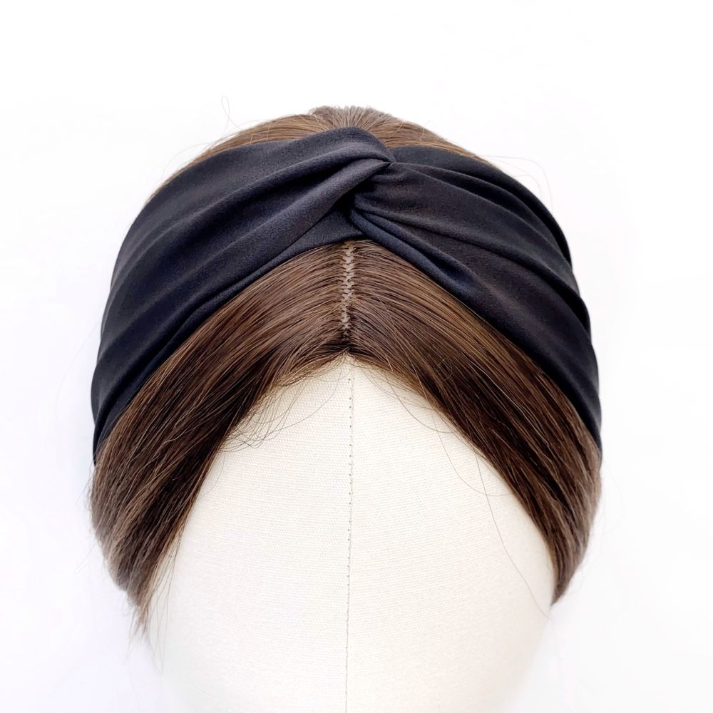 A black twisted mulberry silk headband displayed on a mannequin head.