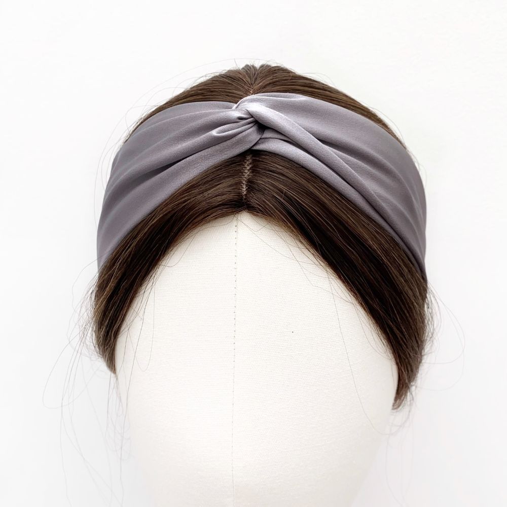 grey twisted mulberry silk satin headband  displayed on a white mannequin head with dark brown hair.
