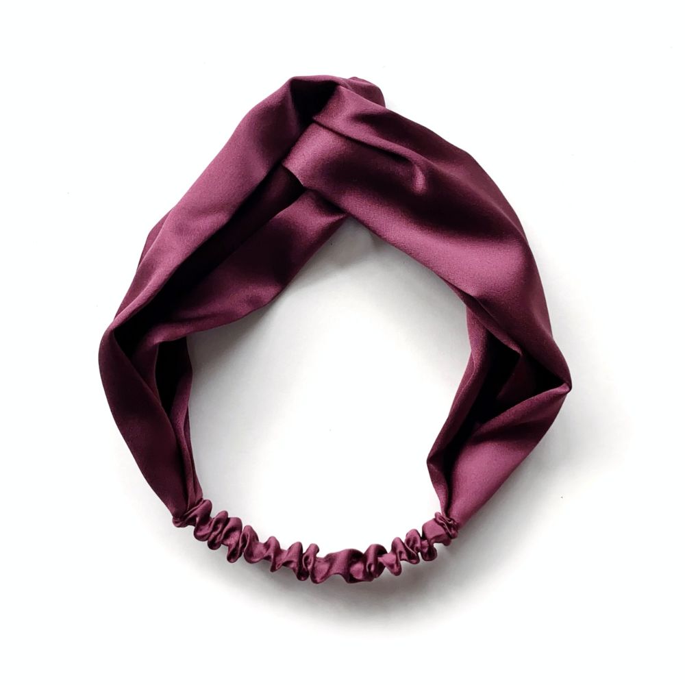 A knotted mulberry silk satin headband in a deep maroon color, displayed on a clean white background.