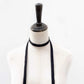 Black mulberry silk choker neck scarf on a mannequin with a white background