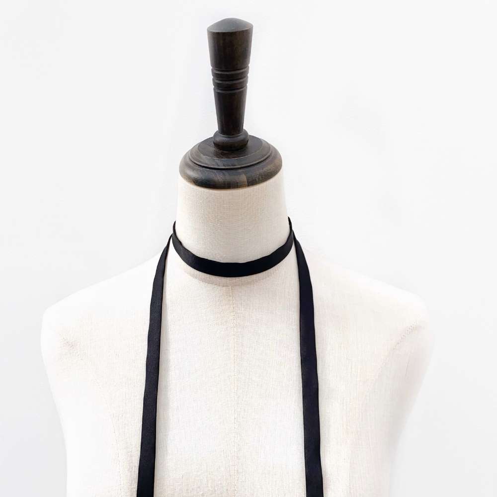 Black mulberry silk choker neck scarf on a mannequin with a white background