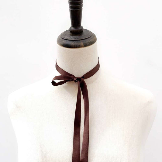 Mannequin wearing a chocolate brown mulberry silk satin ribbon necktie on a white background