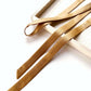 Copper brown ultra skinny mulberry silk satin ribbon on a white surface