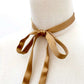 Mannequin wearing a Copper brown ultra skinny mulberry silk ribbon scarf tied around the neck on a white background