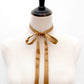Mannequin wearing a Copper brown ultra skinny mulberry silk scarf tied into a bow on a white background