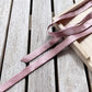 muted purple mulberry silk satin ribbon on a wooden surface