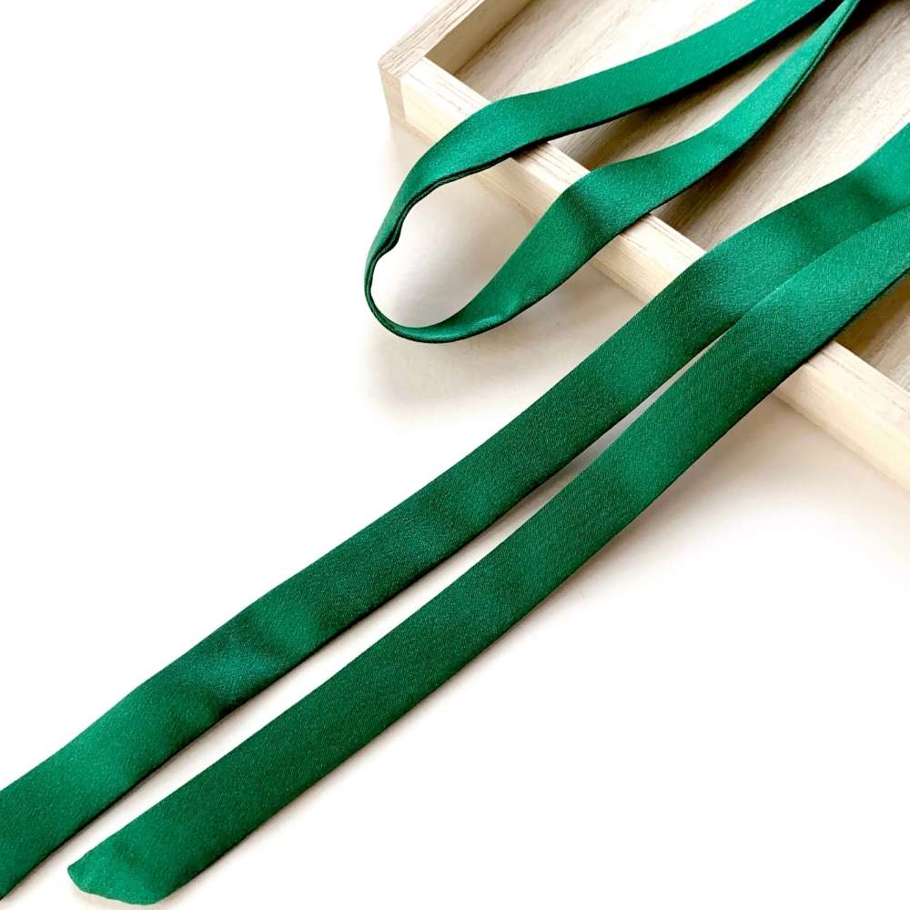 forest green mulberry silk satin ribbon scarf on a white surface