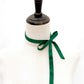Mannequin with forest green mulberry silk satin ribbon scarf tied around its neck on a white background
