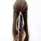 grey mulberry silk ribbon hair tie in a half-up hairstyle on a white background