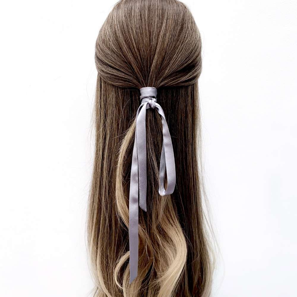 grey mulberry silk ribbon hair tie in a half-up hairstyle on a white background