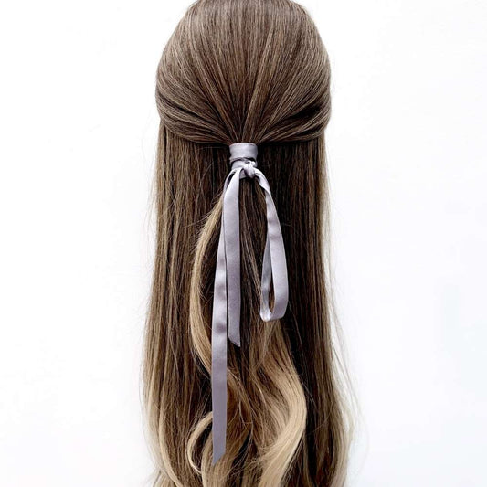 grey mulberry silk ribbon hair tie in a half-up hairstyle on a white background