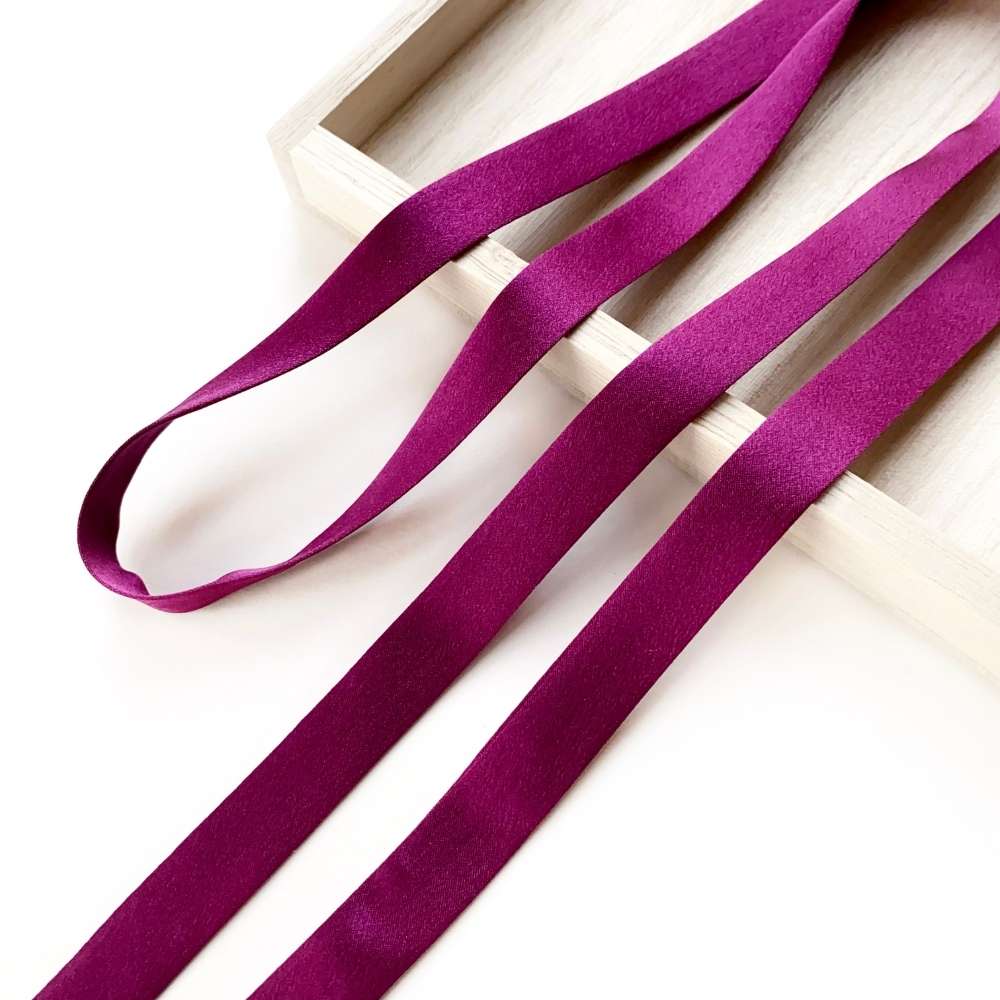 purple mulberry silk satin ribbon on a white surface