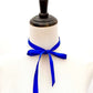 Mannequin with a royal blue silk satin ribbon scarf tied around its neck on a white background