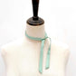 Mannequin wearing a Seafoam green mulberry silk satin ribbon scarf on a white background